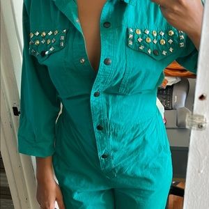 Vintage turquoise jumpsuit with silver and brass details and cinched waist.